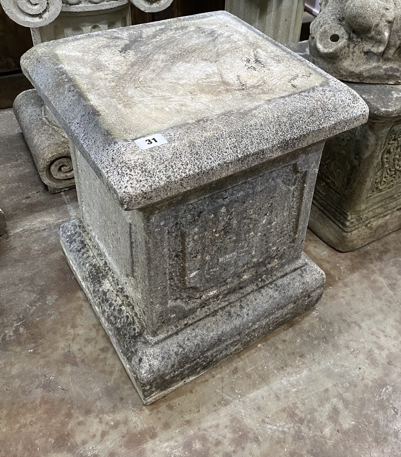 Three reconstituted stone garden plinths, largest width 40cm, height 50cm